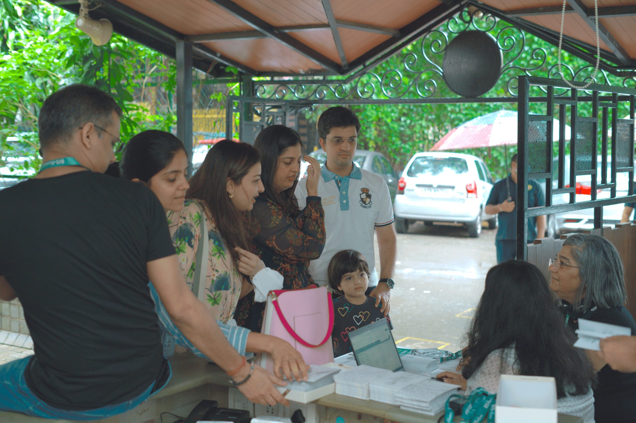 group of alumni at front gate of school