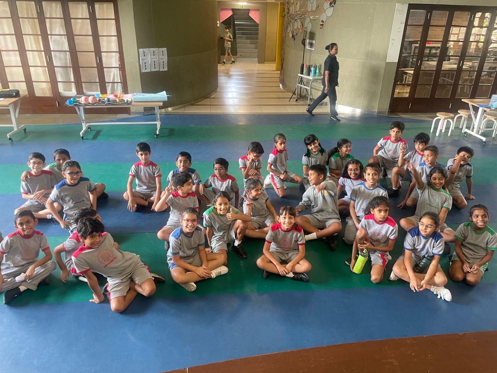 primary kids sitting in the indoor gymnasium