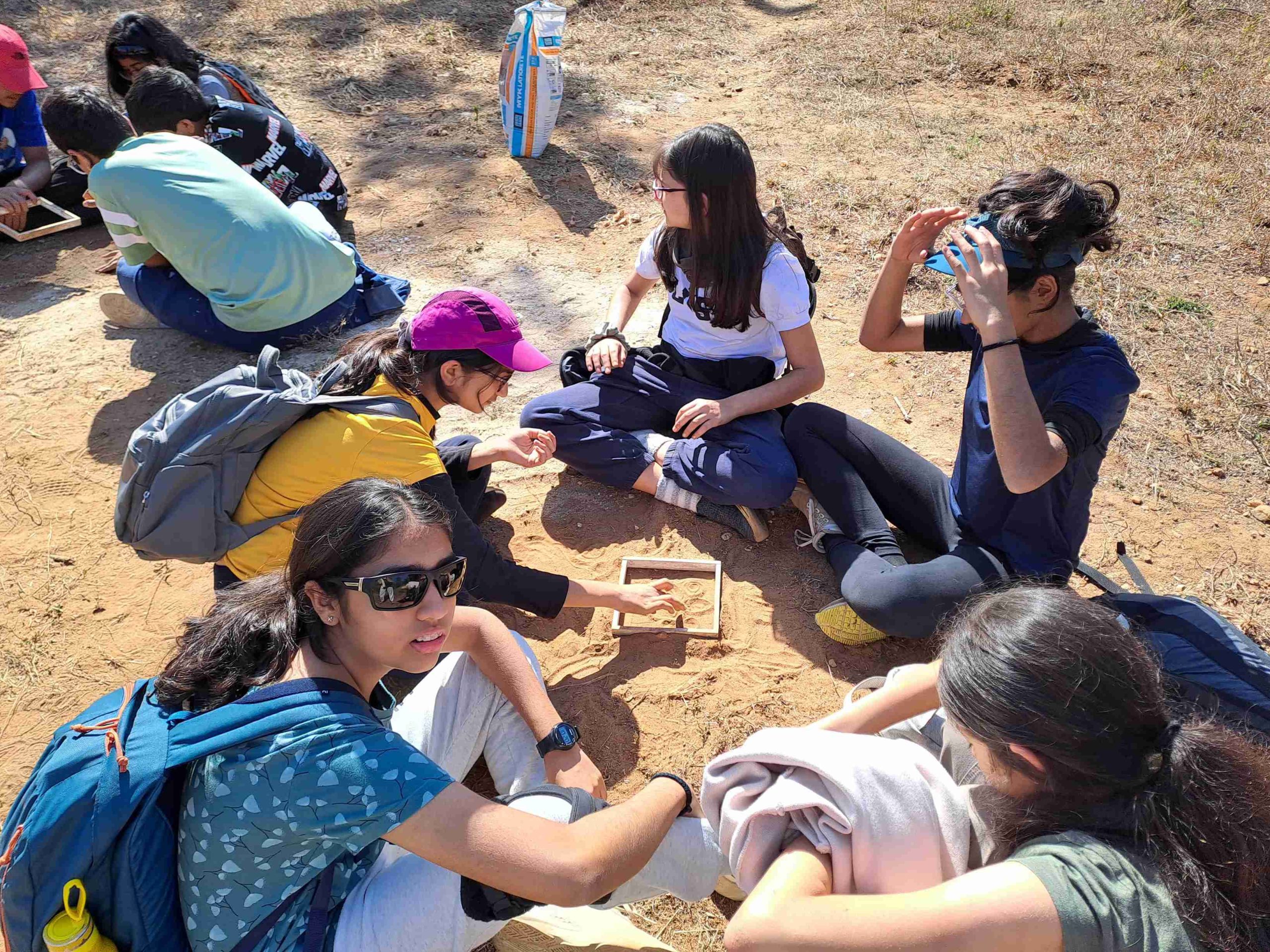 middle school students resting while on a trip with backpacks