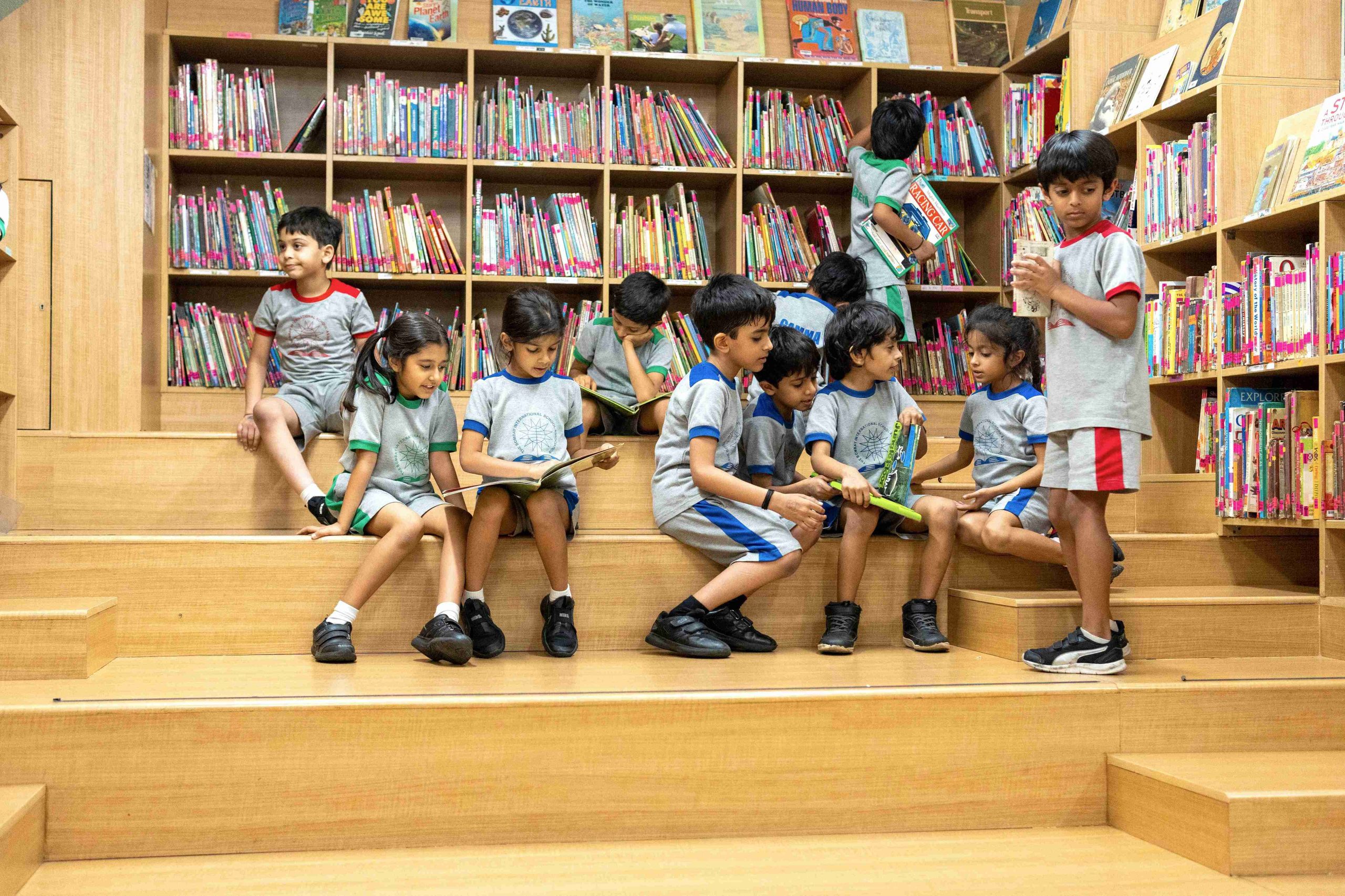 primary kids sitting in the beautiful wooden classroom