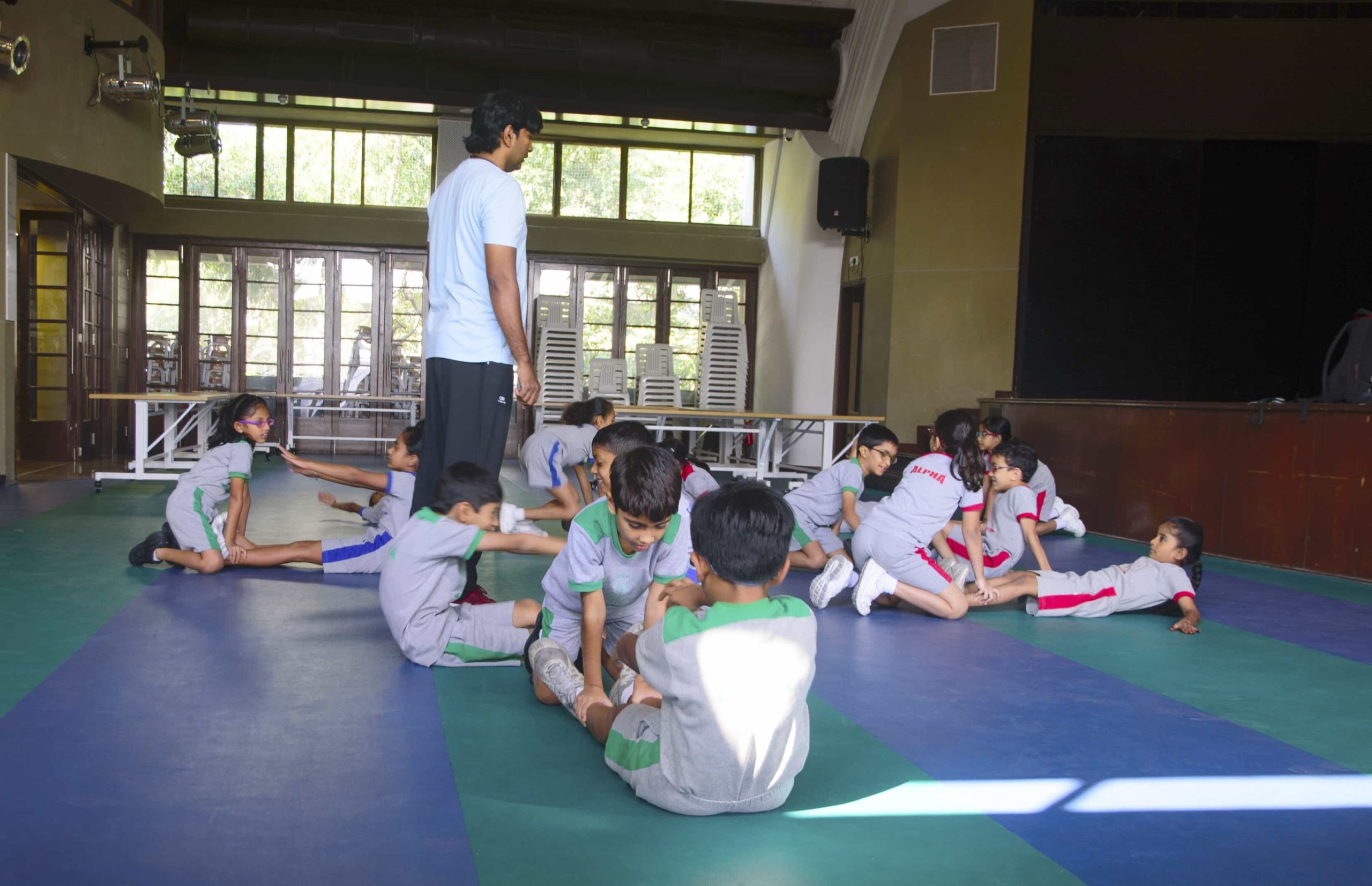 primary kids at gym with instructor