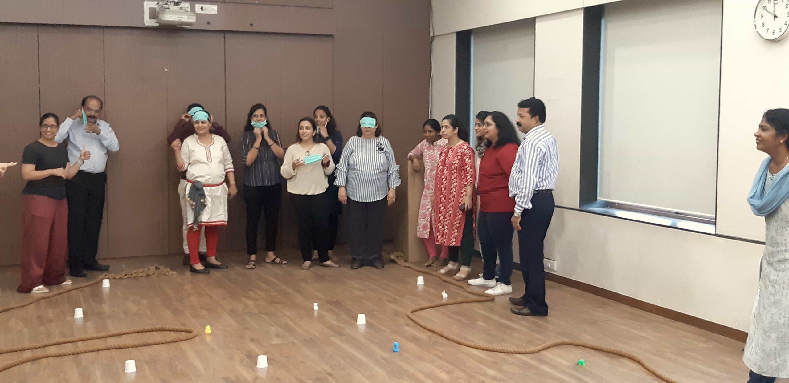 teacher performing a playful activity with blindfolds