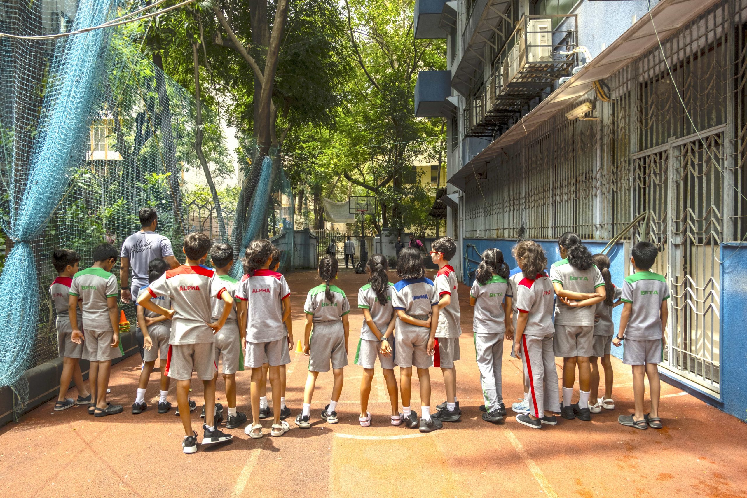 kids are teaming up for a game out in a small playground